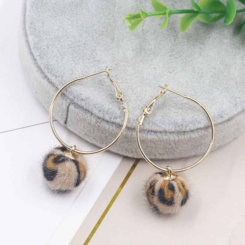 Leopard print fur ball and gold earrings