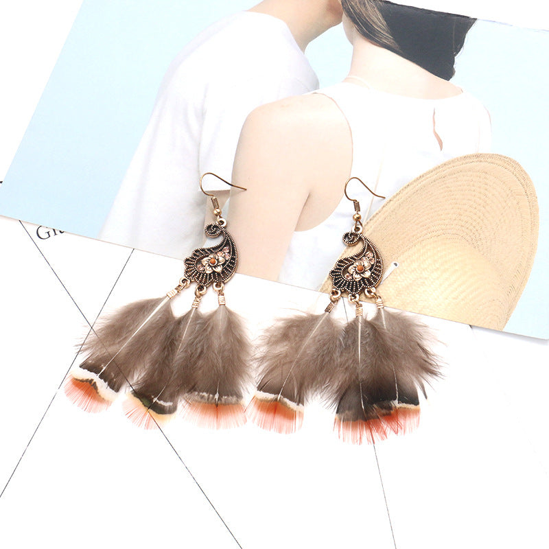 Peacock-studded pierced feather earrings