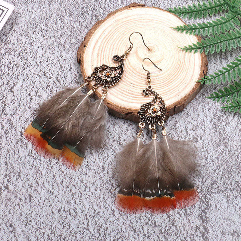 Peacock-studded pierced feather earrings