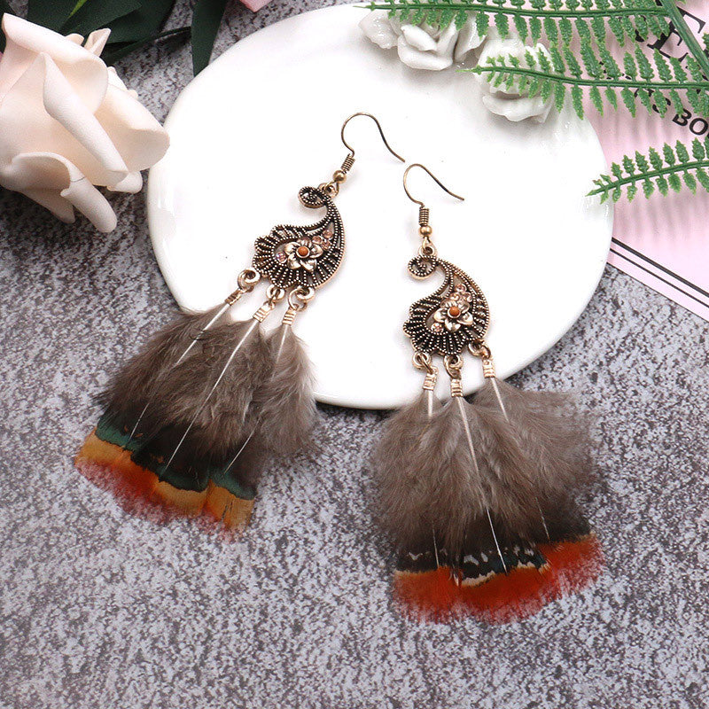 Peacock-studded pierced feather earrings