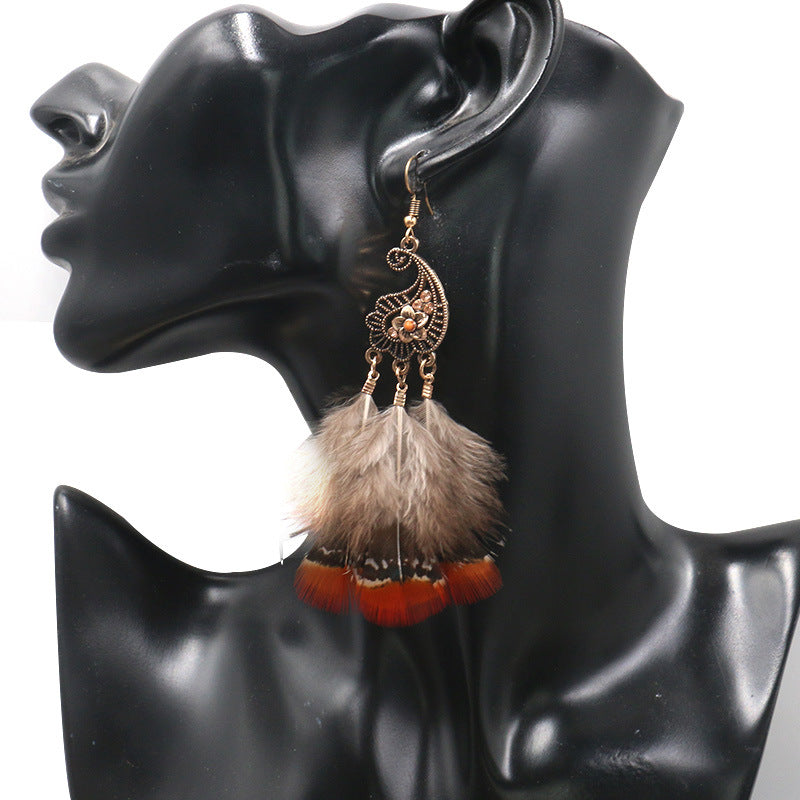 Peacock-studded pierced feather earrings