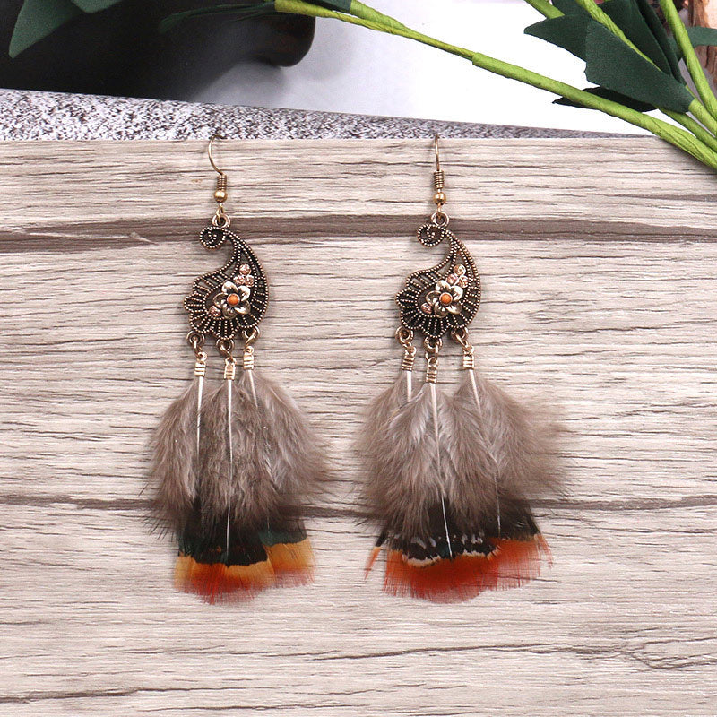 Peacock-studded pierced feather earrings